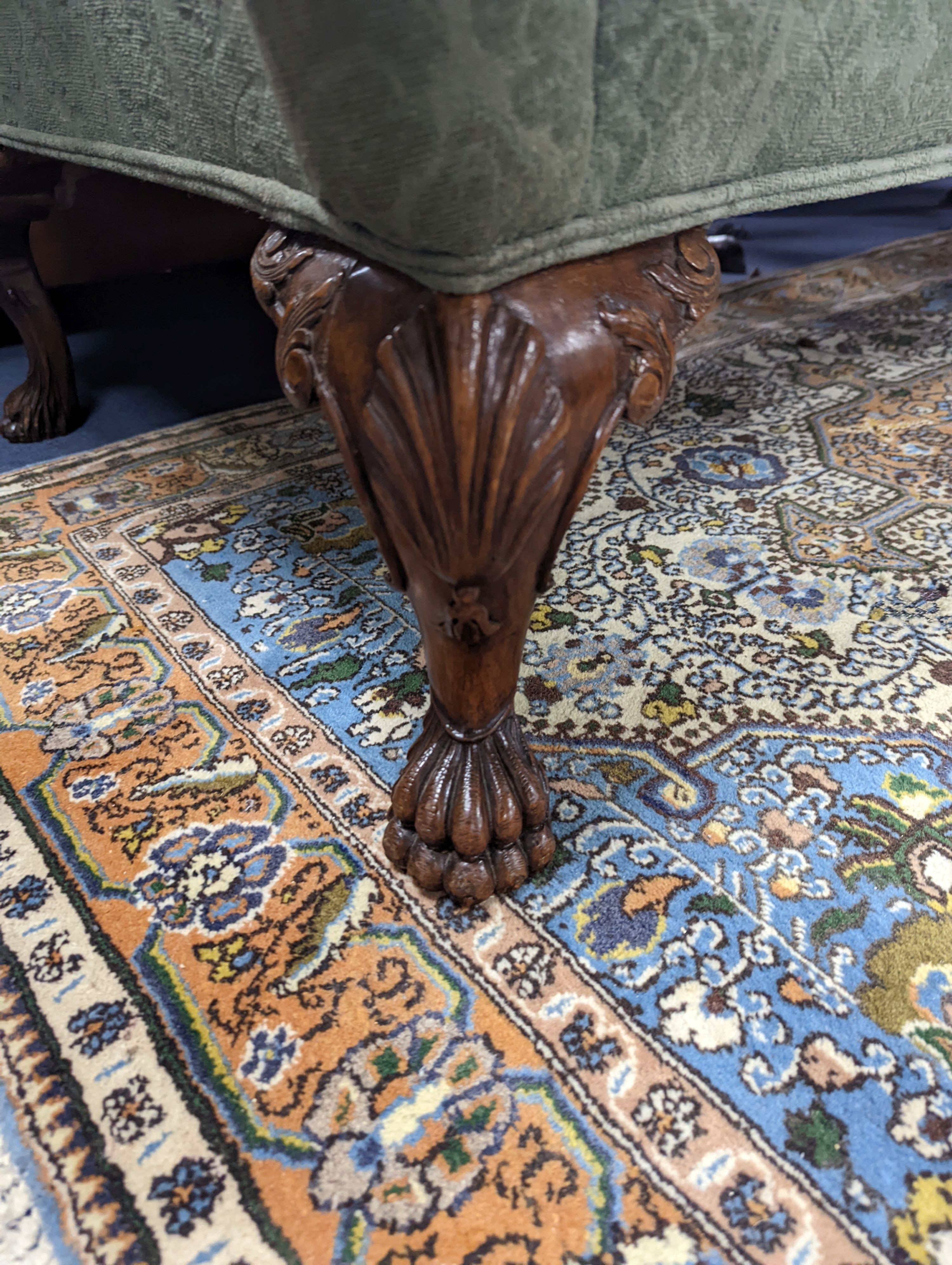 A George I style upholstered carved walnut settee on shell carved cabriole claw feet, length 220cm, depth 80cm, height 94cm